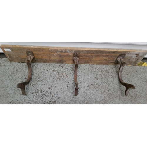 824 - 3 Antique Hooks on a Wooden Board