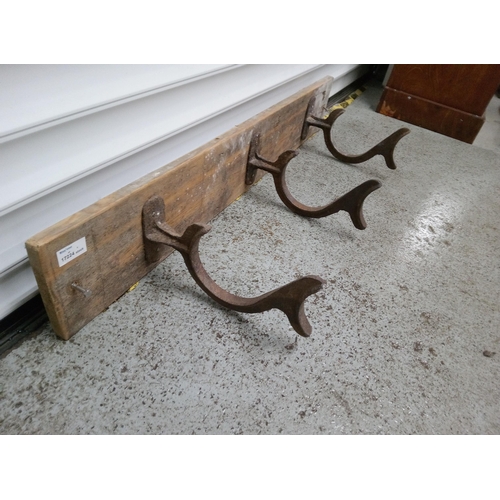 824 - 3 Antique Hooks on a Wooden Board