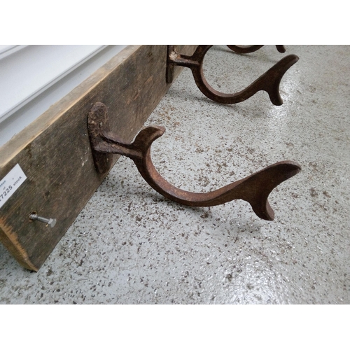 824 - 3 Antique Hooks on a Wooden Board