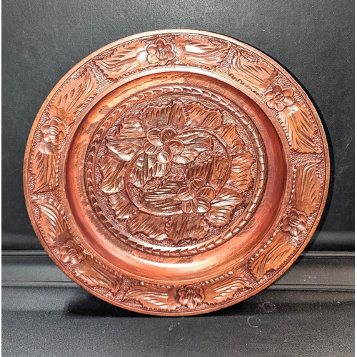 859 - A Hand Carved Wooden Wall Plate. 34cm Diameter.