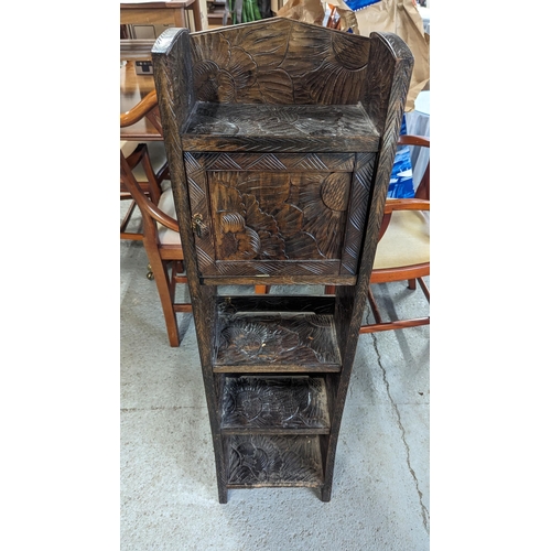 705 - A Heavily Carved Freestanding Shelf/Cupboard Unit. 115cm x 17cm x 31cm.