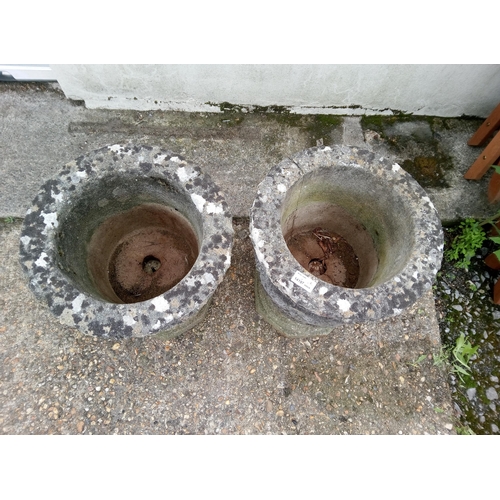 10 - A Pair of Concrete Urns, one with crack as pictured. 43cm H x 35 cm W.