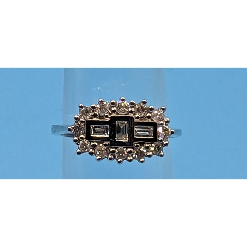 782 - 18ct white gold diamond cluster ring set with round brilliant cut and baguette cut diamonds.  Diamon... 