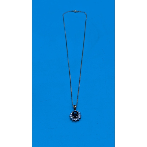 764 - 9ct yellow gold oval sapphire and diamond cluster pendant on a gold coated silver chain.  Sapphire 1... 