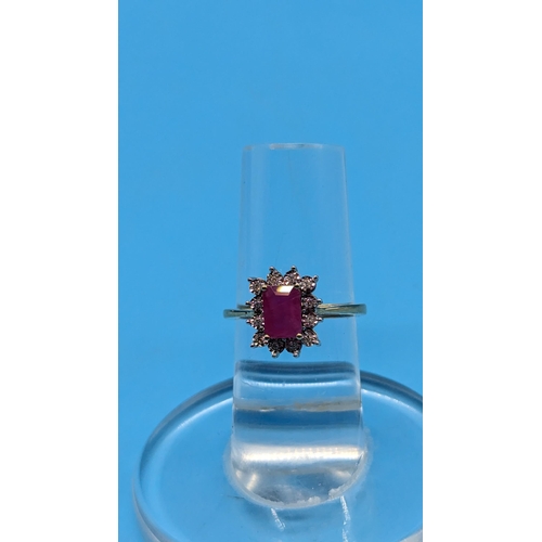 747 - 9ct yellow gold ring set with step cut natural treated ruby and round cut diamond cluster ring.  Rub... 