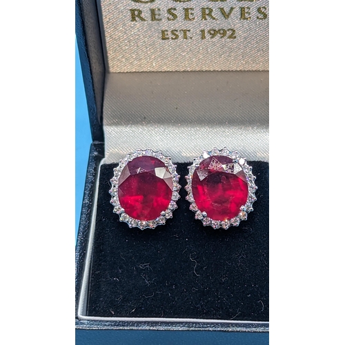 718 - 18ct white gold ruby and diamond cluster earrings.  Rubies (glass filled) 8.71ct.  Diamonds 0.80ct. ... 