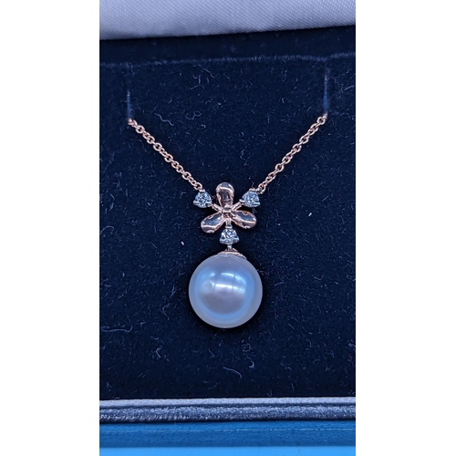 763 - 9ct rose gold pearl and diamond pendant on a 9ct rose gold chain.  Diamond 0.10ct.  Boxed