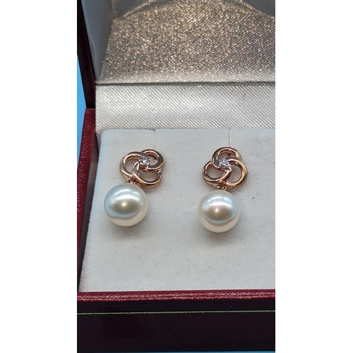 717 - Pair 9ct rose gold pearl and diamond earrings.  Diamonds 0.05ct.  Boxed