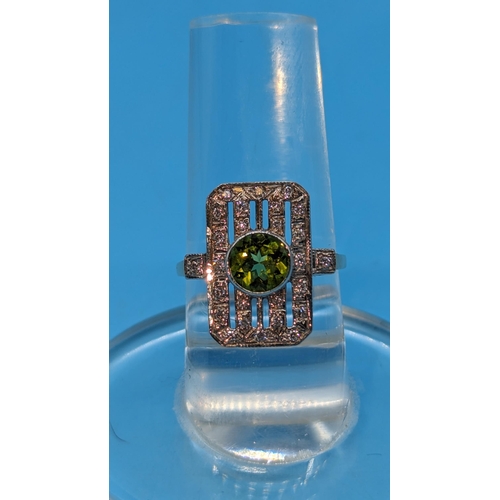 724 - 9ct white and yellow gold peridot and diamond art deco style ring.  Peridot 0.85ct.  Diamonds 0.26ct... 