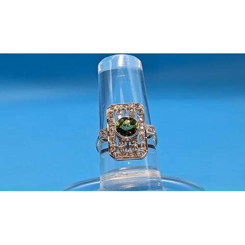 724 - 9ct white and yellow gold peridot and diamond art deco style ring.  Peridot 0.85ct.  Diamonds 0.26ct... 