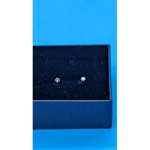 767 - Pair of platinum 6 claw solitaire diamond studs with rubber platinum backs.  Diamonds 0.20ct.  Boxed