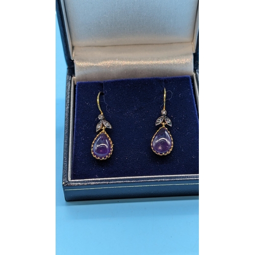 727 - Pair of 9ct yellow gold and silver drop earrings set with pear shaped cabochon amethyst and diamonds... 