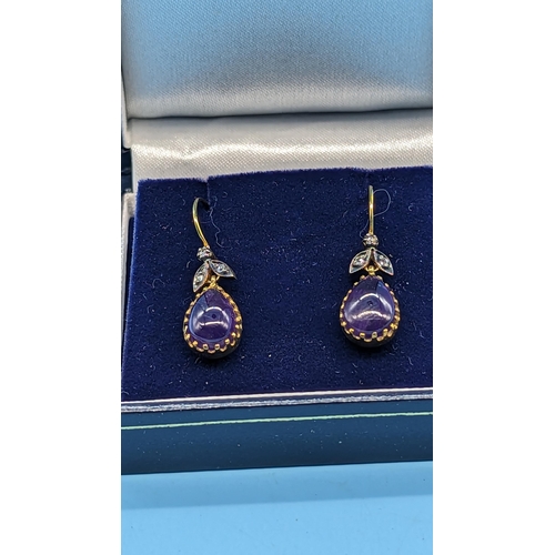 727 - Pair of 9ct yellow gold and silver drop earrings set with pear shaped cabochon amethyst and diamonds... 