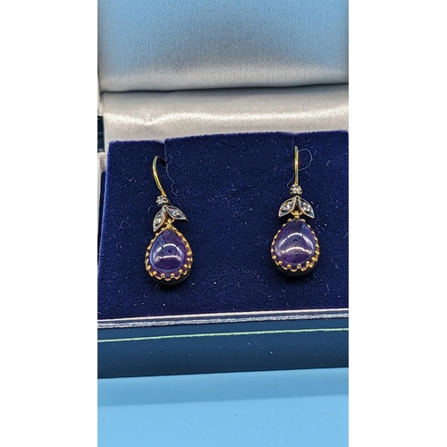 727 - Pair of 9ct yellow gold and silver drop earrings set with pear shaped cabochon amethyst and diamonds... 