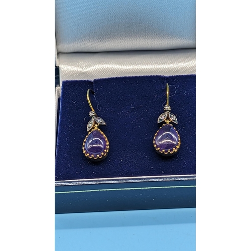 727 - Pair of 9ct yellow gold and silver drop earrings set with pear shaped cabochon amethyst and diamonds... 