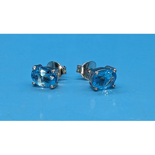 775 - Pair oval swiss blue topaz studs in silver