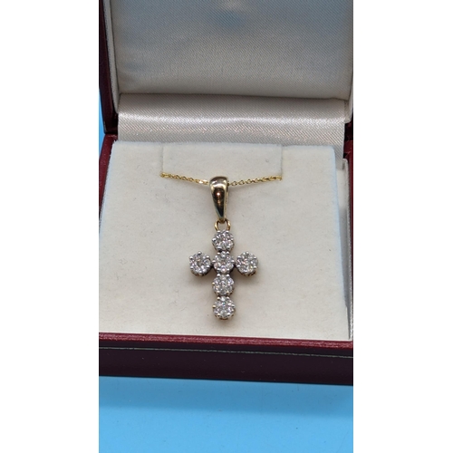 722 - 9ct yellow gold diamond cluster cross pendant.  Diamonds approx. 1.00ct on a gold plated silver chai... 