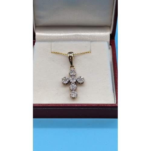 722 - 9ct yellow gold diamond cluster cross pendant.  Diamonds approx. 1.00ct on a gold plated silver chai... 