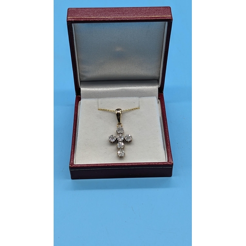 722 - 9ct yellow gold diamond cluster cross pendant.  Diamonds approx. 1.00ct on a gold plated silver chai... 