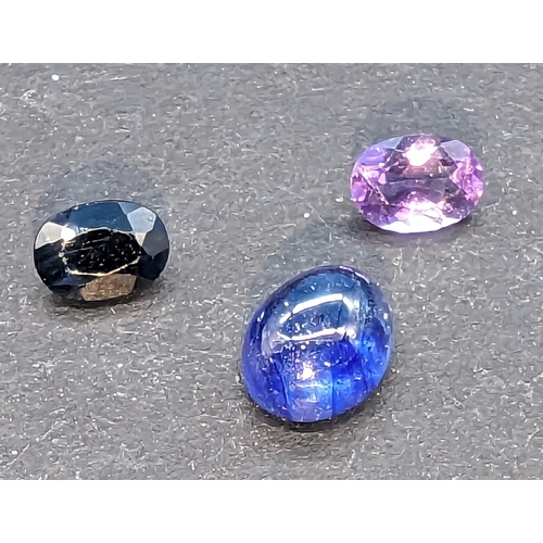 779 - Parcel of three gemstones, amethyst, sapphire and cabochon sapphire.  5.45ct