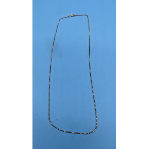 799 - A 9ct (Stamped 375) Yellow Gold Bead Necklace. 50 cm.