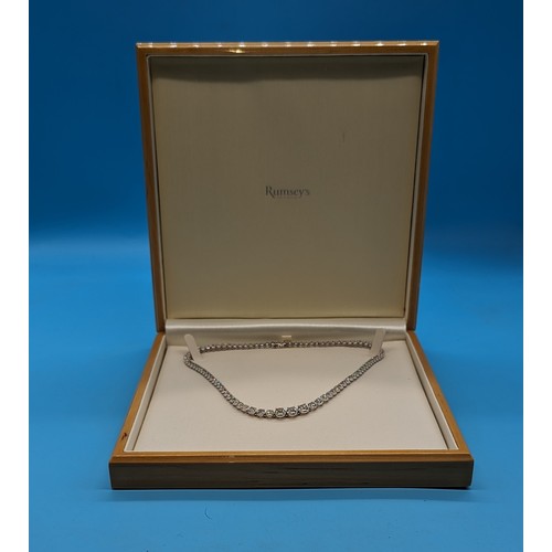 715 - 9ct white gold graduated round brilliant cut diamond line necklace.  Diamonds 12.00ct.  Boxed