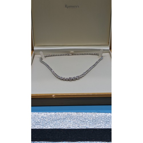 715 - 9ct white gold graduated round brilliant cut diamond line necklace.  Diamonds 12.00ct.  Boxed