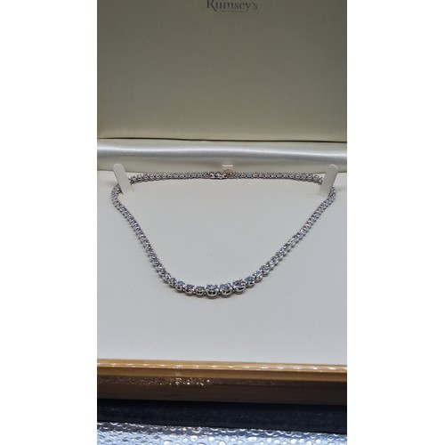 715 - 9ct white gold graduated round brilliant cut diamond line necklace.  Diamonds 12.00ct.  Boxed