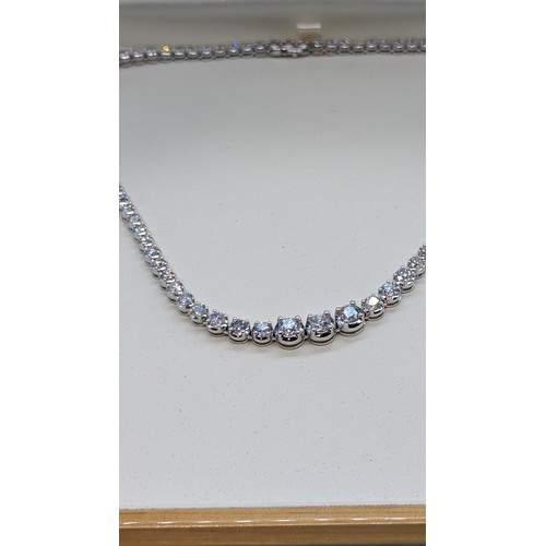 715 - 9ct white gold graduated round brilliant cut diamond line necklace.  Diamonds 12.00ct.  Boxed