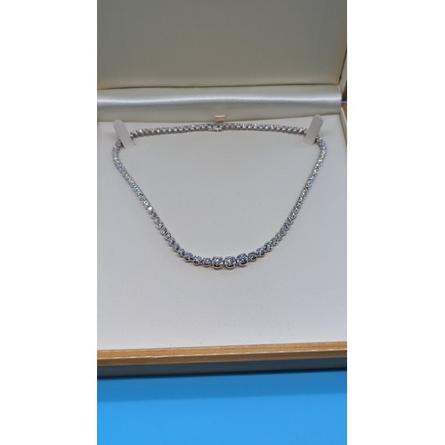 715 - 9ct white gold graduated round brilliant cut diamond line necklace.  Diamonds 12.00ct.  Boxed