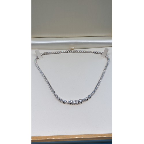 715 - 9ct white gold graduated round brilliant cut diamond line necklace.  Diamonds 12.00ct.  Boxed