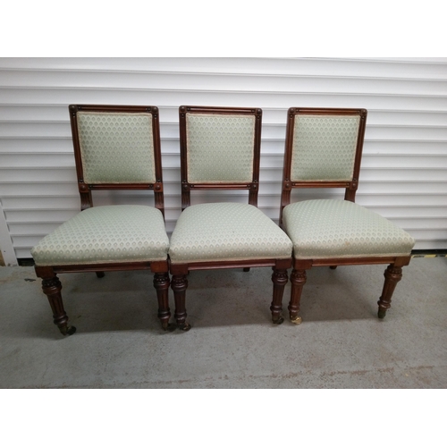 1243 - 3 Light Green Upholstered Dark Wood Chairs with Castors on front legs.