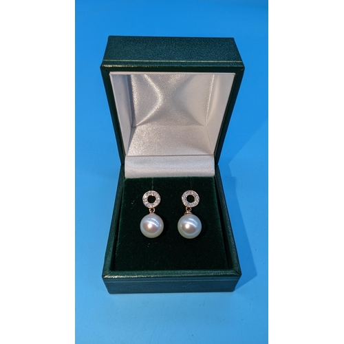 489 - Pair 9ct rose gold pearl and diamond drop earrings.  Diamonds 0.15ct.  Boxed