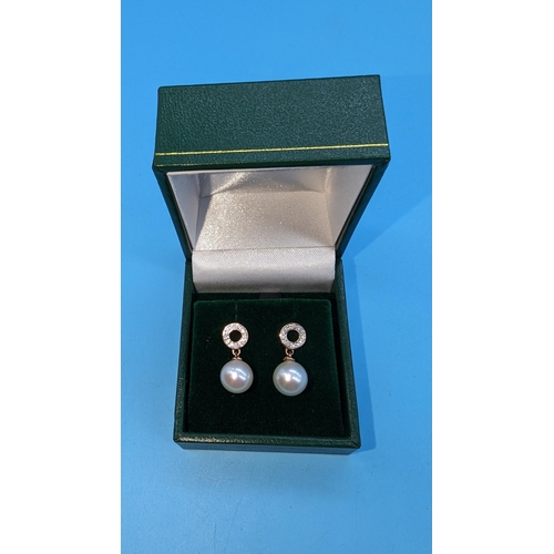 489 - Pair 9ct rose gold pearl and diamond drop earrings.  Diamonds 0.15ct.  Boxed