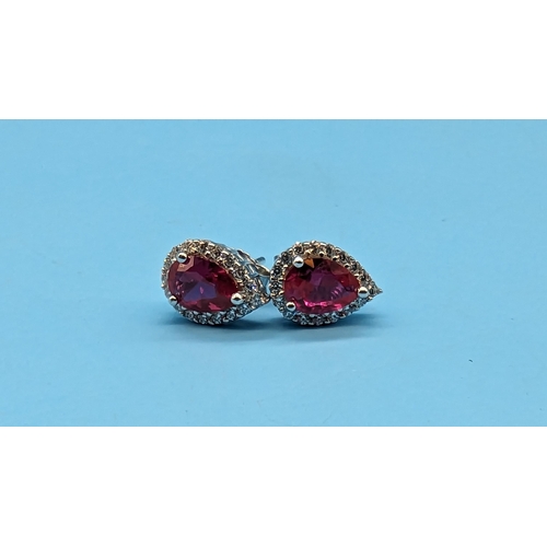 520 - Pair of silver cluster studs set with pear shaped red cubic zirconia and white round cubic zirconia ... 