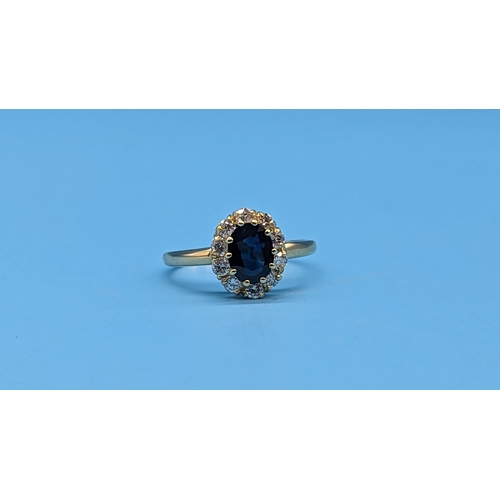 453 - 18ct yellow gold sapphire and diamond cluster ring.  Sapphire 1.50ct.  Diamonds 0.60ct.  WGI Cert. n... 