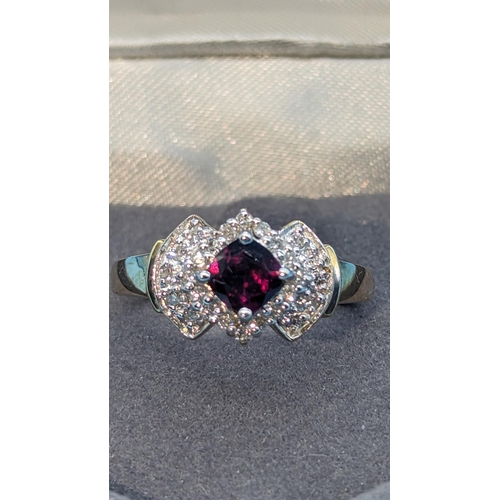 473 - 9k yellow gold halo ring with garnets and diamonds. Garnet 0.50ct approx. Diamonds 0.32ct approx.   ... 