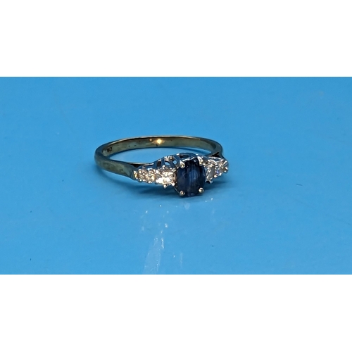 475 - 9ct yellow and white gold oval sapphire and diamond ring. Sapphire 0.50ct. Diamonds 0.25ct.