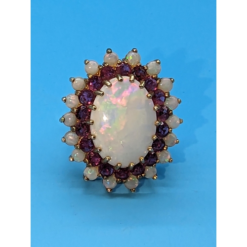 459 - A Large White Opal and Amethyst Cocktail Ring in a 9ct Yellow Gold Setting.