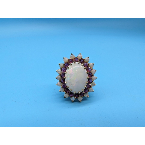 459 - A Large White Opal and Amethyst Cocktail Ring in a 9ct Yellow Gold Setting.