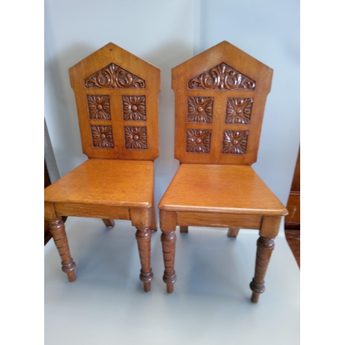 389 - A Pair of Antique Carved Hall Chairs.