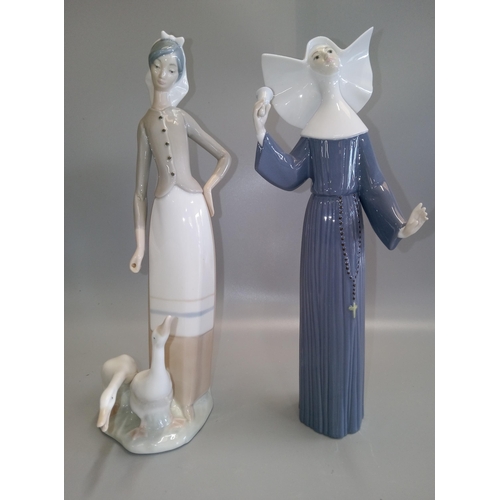 696 - 2 Lladro Figurines, one nun and a girl with geese.