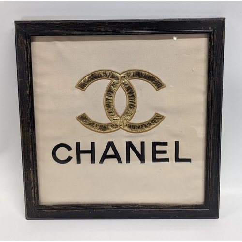 669 - A Chanel Fabric Logo, Framed. 42 x 44cm In Frame.