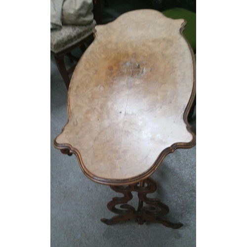 394 - Carved Occasional Table with Walnut Veneer Top and Castors. 
75cm H x 90cm L x 41cm W.