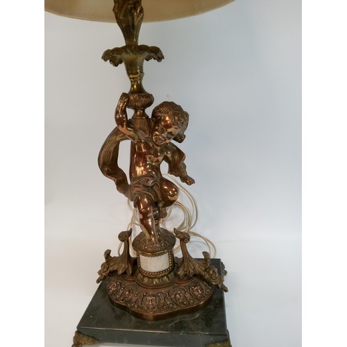 593 - A Heavy Bronze Cherub/Putti Lamp on a Black Marble Base. 72cm High with Shade, 54cm High Without Sha... 