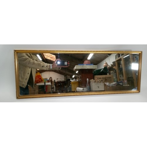 235C - A Gilt Framed Rectangular Mirror 94cm x 33cm.