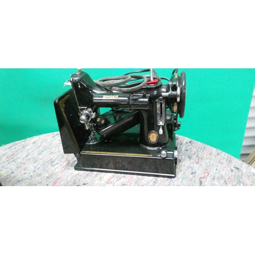 714 - A Singer Sewing Machine in Hard Shell Case