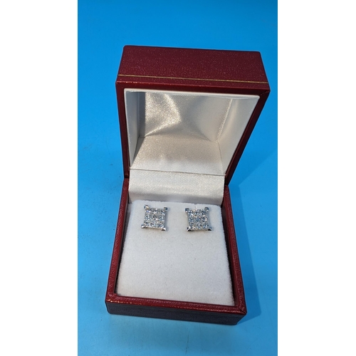 581 - Certificated pair of 18ct white gold 9 stone princess cut invisible set square stud earrings.  Diamo... 