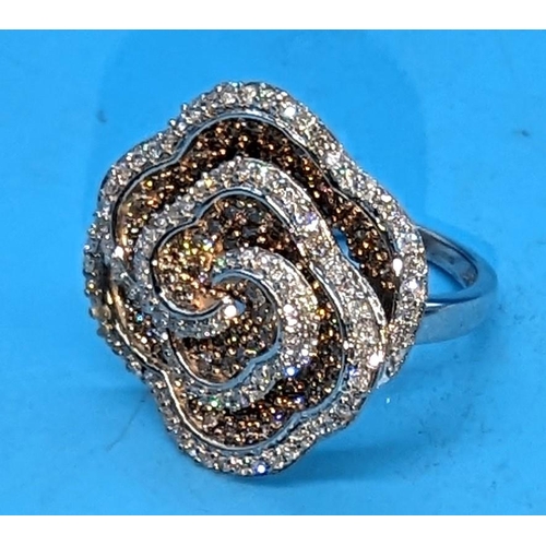 595 - Large 9ct white gold and rose swirling floral ring set with yellow and white diamonds.  Approx. 1.50... 