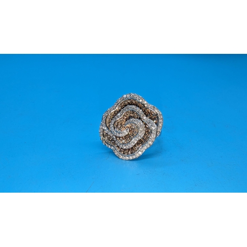 595 - Large 9ct white gold and rose swirling floral ring set with yellow and white diamonds.  Approx. 1.50... 